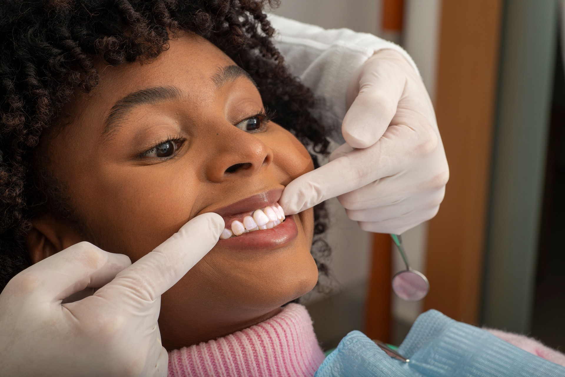 Dentist examining patient's teeth in dental clinic
